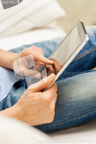 Image of close up of man working with tablet pc at home