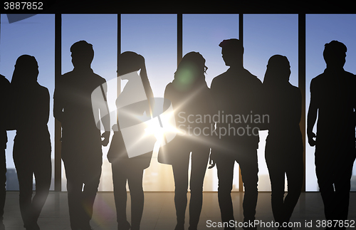 Image of people silhouettes over office background