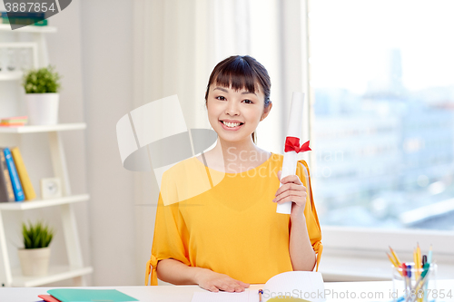 Image of happy asian woman student with diploma at home