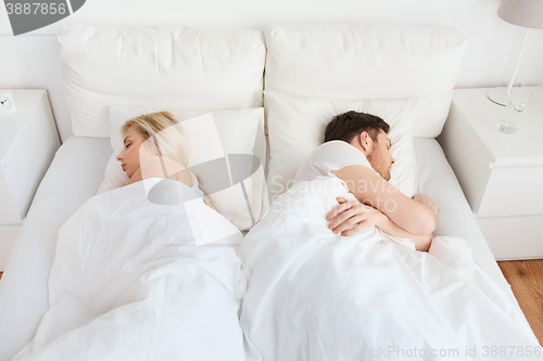 Image of couple sleeping in bed at home