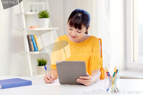 Image of asian woman student with tablet pc at home