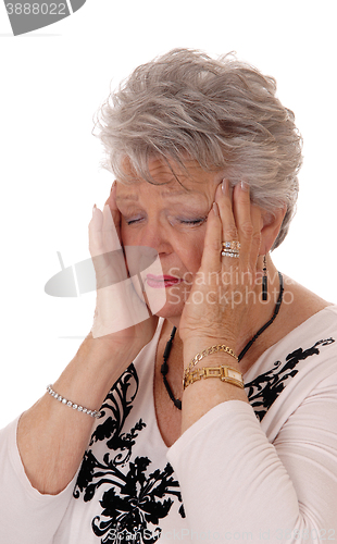 Image of Senior woman holding her head for headache.