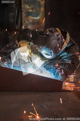 Image of worker welding metal