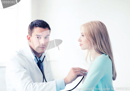 Image of doctor with stethoscope listening to the patient