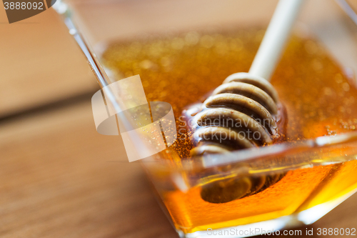 Image of close up of honey in glass bowl and dipper