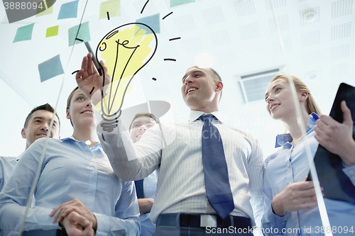 Image of smiling business people with marker and stickers