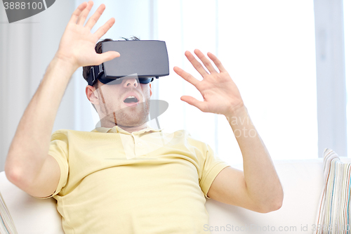 Image of young man in virtual reality headset or 3d glasses