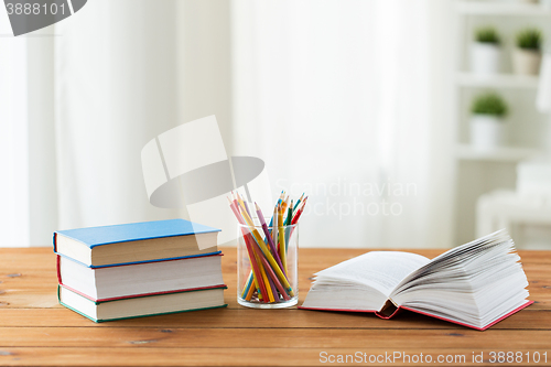 Image of close up of crayons or color pencils and books