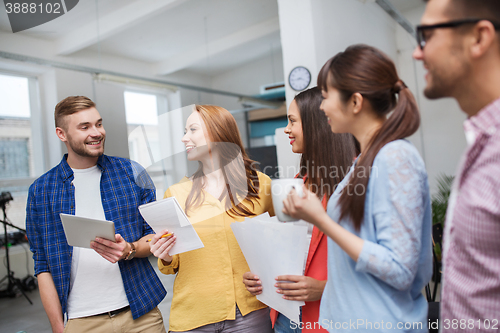 Image of creative team on coffee break talking at office