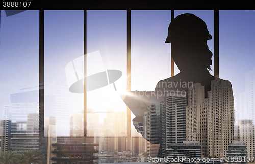 Image of silhouette of woman in helmet with clipboard