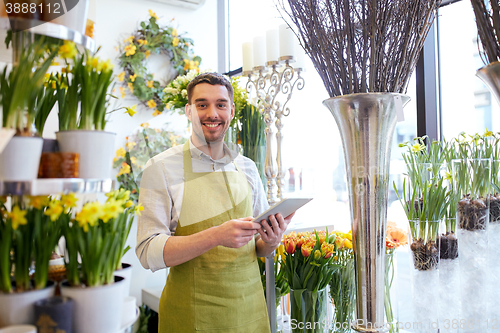 Image of man with tablet pc computer at flower shop