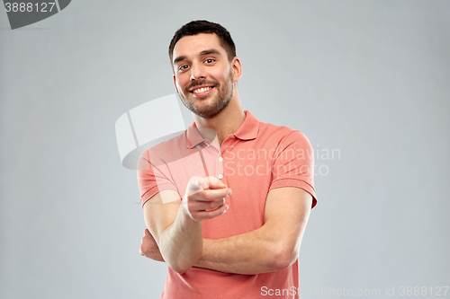 Image of man pointing finger to you over gray background