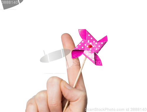 Image of close up of hand holding pinwheel toy