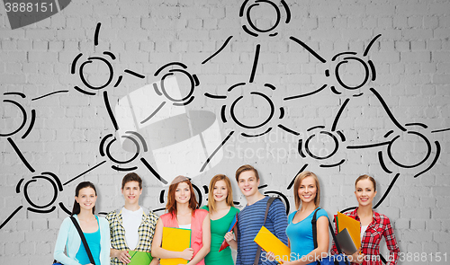 Image of group of teenage students with folders and bags