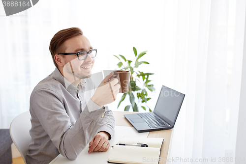 Image of creative man or businessman drinking coffee