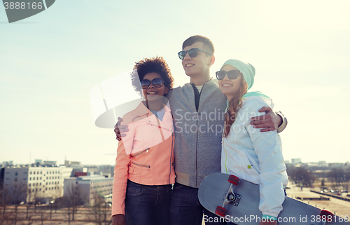 Image of happy teenage friends in shades talking on street