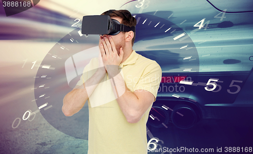 Image of man in virtual reality headset and car racing game