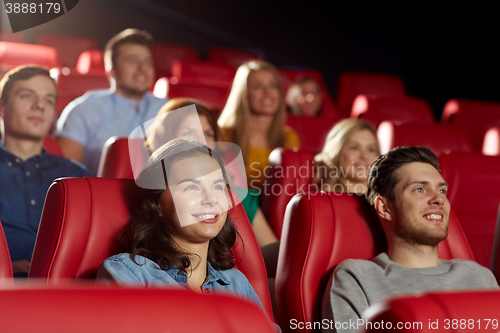 Image of happy friends watching movie in theater