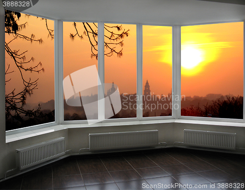 Image of plastic windows overlooking the fiery red sunset