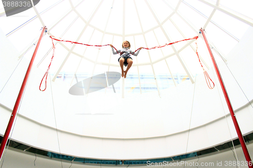 Image of girl jumps on the trampoline