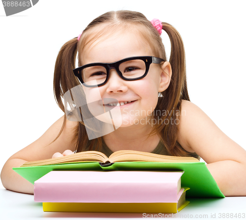 Image of Little girl is reading a book