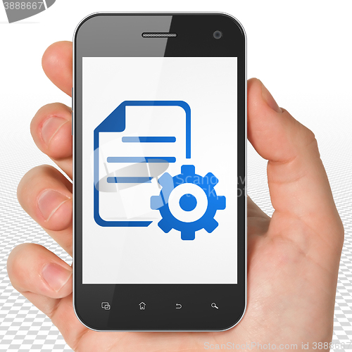 Image of Database concept: Hand Holding Smartphone with Gear on display