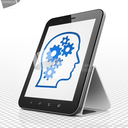 Image of Learning concept: Tablet Computer with Head With Gears on display