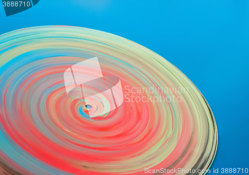 Image of Painted colorful disc on a blue background