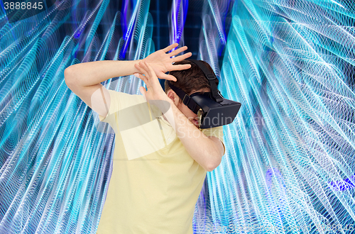 Image of happy man in virtual reality headset or 3d glasses