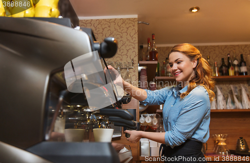 Image of barista woman making coffee by machine at cafe