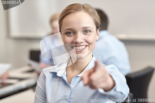 Image of smiling businesswoman pointing finger on you