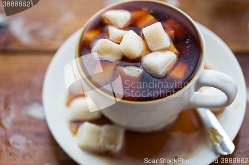 Image of close up of sugar in coffee cup on wooden table