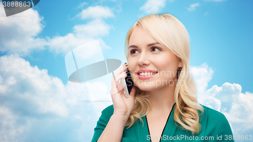 Image of happy young woman calling on smartphone