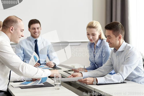 Image of business people with papers meeting in office