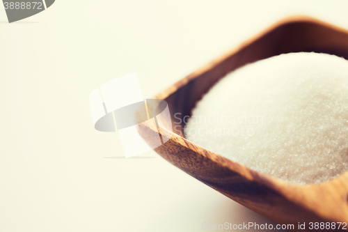 Image of close up of white sugar heap in wooden bowl