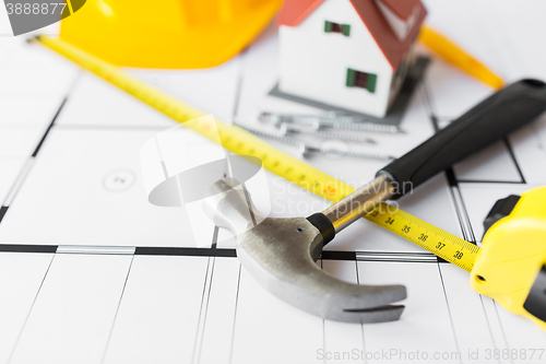 Image of close up of house blueprint with building tools