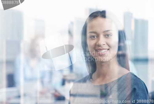 Image of group of smiling businesspeople meeting in office