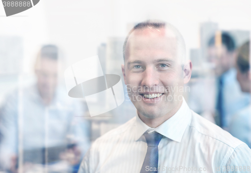 Image of group of smiling businesspeople meeting in office