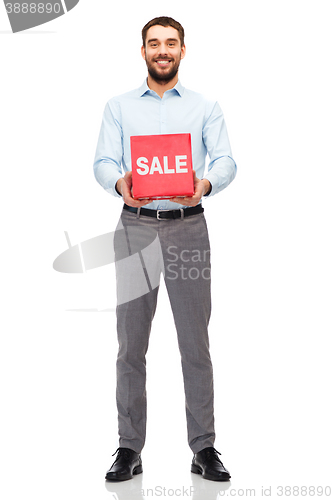 Image of smiling man with red shopping bag