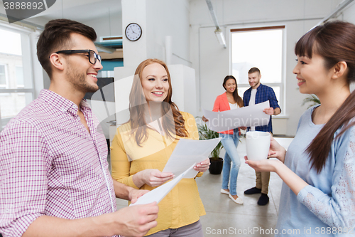 Image of creative team on coffee break talking at office