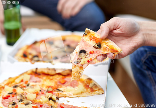 Image of close up of friends with beer and pizza at home