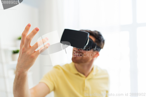 Image of young man in virtual reality headset or 3d glasses