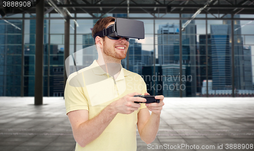 Image of happy man in virtual reality headset with gamepad