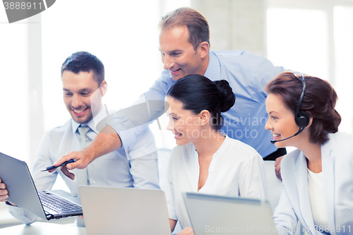 Image of group of people working in call center