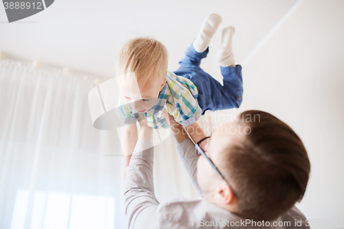 Image of father with son playing and having fun at home