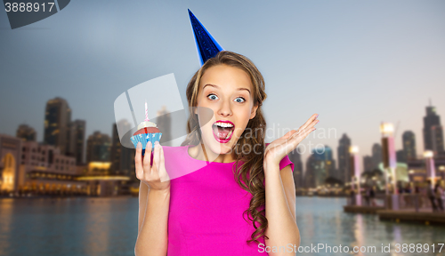 Image of happy woman or teen girl with birthday cupcake