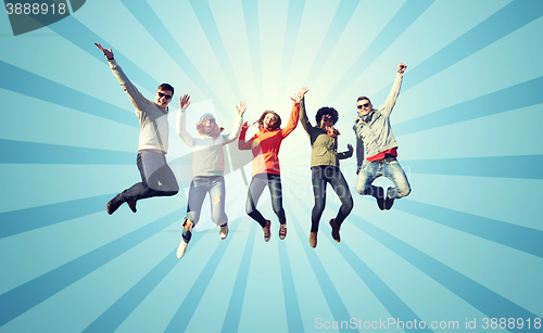 Image of smiling friends in sunglasses jumping high