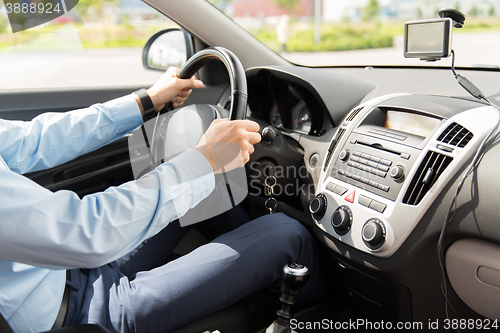 Image of close up of young man driving car