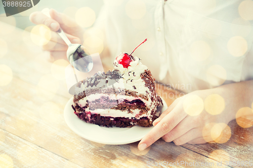 Image of close up of woman eating chocolate cherry cake