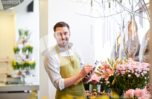 Image of florist man with clipboard at flower shop